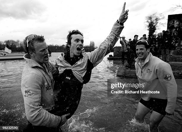 Cambridge Cox Ted Randolph celebrates victory with team mate Fred Gill after the 156th Oxford and Cambridge University Boat Race on the River Thames...