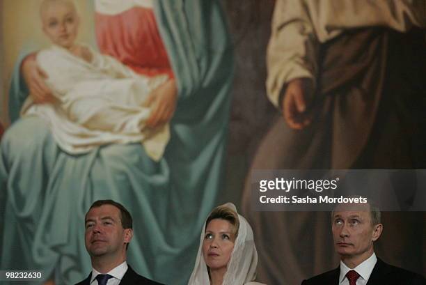 Russian President Dmitry Medvedev, his spouse Svetlana Medvedeva and Prime Minister Vladimir Putin attend an Easter celebration mess at the Christ...
