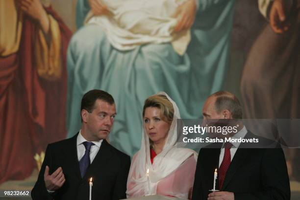 Russian President Dmitry Medvedev, his spouse Svetlana Medvedeva and Prime Minister Vladimir Putin attend an Easter celebration mess at the Christ...