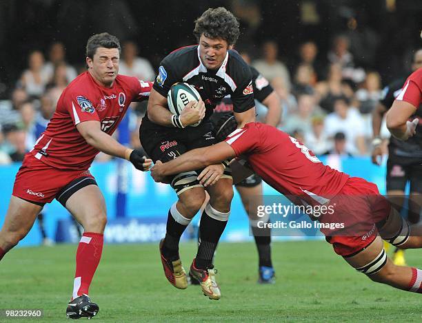 Ryan Kankowski of the Sharks tackled by Scott Higginbotham and Jake Schatz of the Reds during the Super 14 match between Sharks and Reds from Absa...