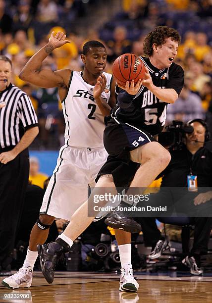 Matt Howard of the Butler Bulldogs drives against Raymar Morgan of the Michigan State Spartans during the National Semifinal game of the 2010 NCAA...