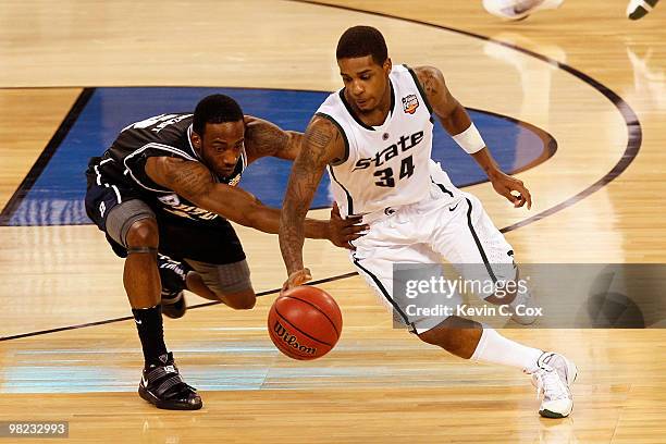 Korie Lucious of the Michigan State Spartans moves the ball as Shawn Vanzant of the Butler Bulldogs goes for a steal during the National Semifinal...