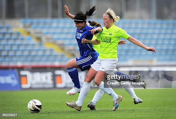 Sylvia Arnold of Jena and Daniela Loewenberg of Essen-Schoenebeck battle for the ball during the DFB women's cup half final match between FF USV Jena...