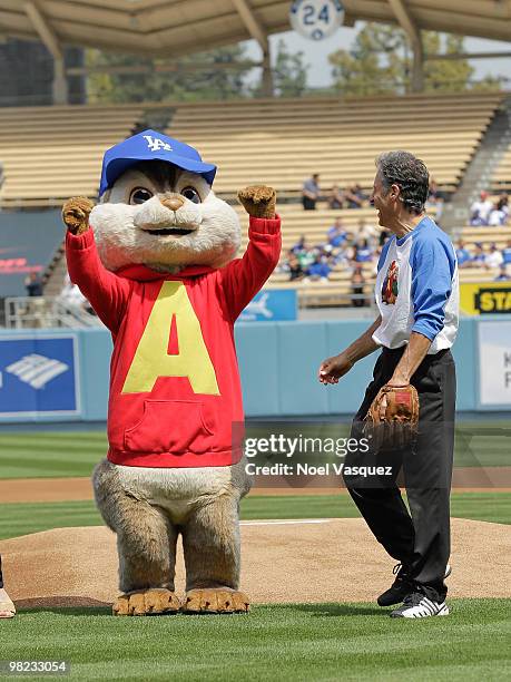Ross Bagdasarian Jr and a person dressed as the character 'Alvin' of the Chipmunks throws the first pitch at the "Alvin And The Chipmunks: The...