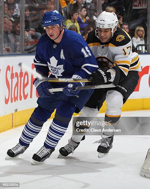 Milan Lucic of the Boston Bruins tries to check Tomas Kaberle of the Toronto Maple Leafs in a game on April 3, 2010 at the Air Canada Centre in...