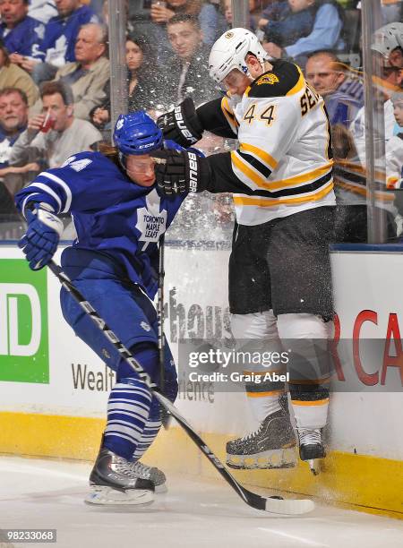 Mikhail Grabovski of the Toronto Maple Leafs checks Dennis Seidenberg of the Boston Bruins during game action April 3, 2010 at the Air Canada Centre...