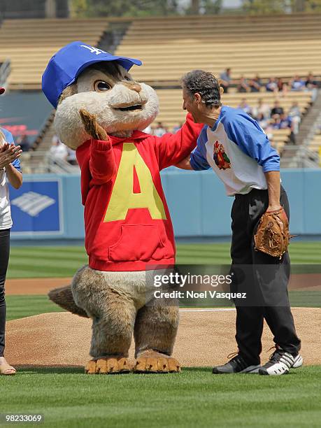 Ross Bagdasarian Jr and a person dressed as the character 'Alvin' of the Chipmunks throws the first pitch at the "Alvin And The Chipmunks: The...