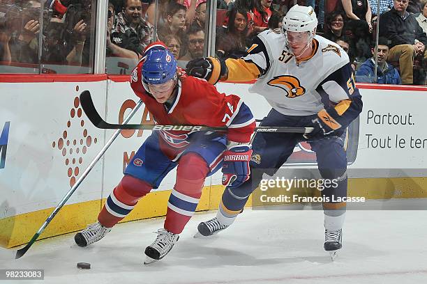 Sergei Kostitsyn of Montreal Canadiens skates with the puck in front of Tyler Myers of Buffalo Sabres during the NHL game on April 3, 2010 at the...