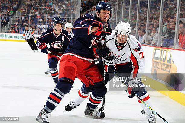 Marc Methot of the Columbus Blue Jackets gets called for roughing with this hit on Brooks Laich of the Washington Capitals on April 3, 2010 at...