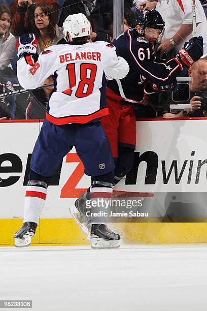 Eric Belanger of the Washington Capitals finishes a check on Rick Nash of the Columbus Blue Jackets during the first period on April 3, 2010 at...