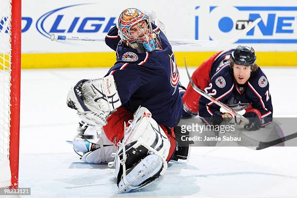 Goaltender Mathieu Garon of the Columbus Blue Jackets is unable to stop the shot from Tomas Fleischmann of the Washington Capitals during the first...