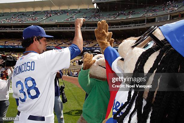 People dressed as the characters 'Alvin, Simon and Theodore' greet Los Angeles Dodger Ramon Troncoso at the "Alvin And The Chipmunks: The Squeakquel"...