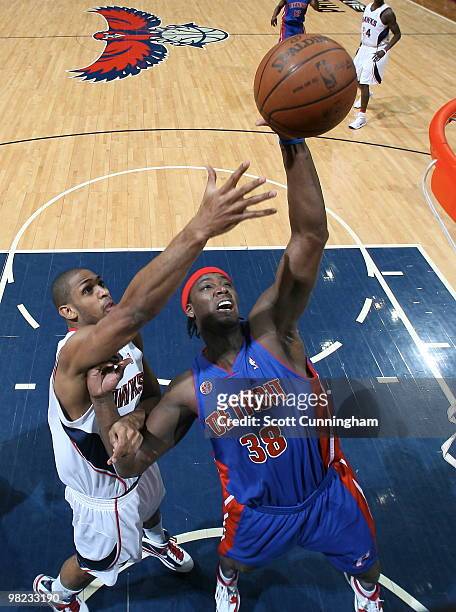Kwame Brown of the Detroit Pistons grabs a rebound against Al Horford of the Atlanta Hawks on April 3, 2010 at Philips Arena in Atlanta, Georgia....