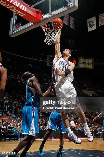 Brook Lopez of the New Jersey Nets dunks against Emeka Okafor of the New Orleans Hornets during a game on April 3, 2010 at Izod Center in East...