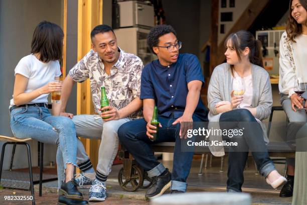 group of friends drinking together - jgalione stock pictures, royalty-free photos & images