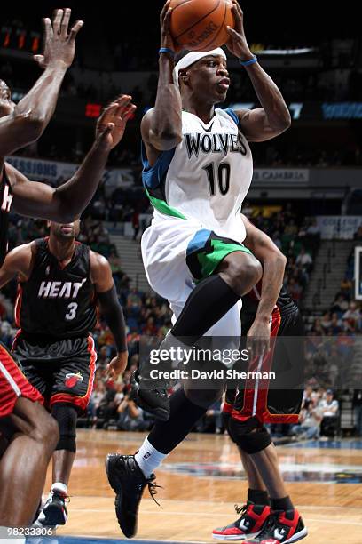 Jonny Flynn of the Minnesota Timberwolves passes against Jamaal Magloire, Dwyane Wade, and Joel Anthony of the Miami Heat during the game on April 3,...