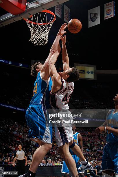 Kris Humphries of the New Jersey Nets shoots against Aaron Gray of the New Orleans Hornets during a game on April 3, 2010 at Izod Center in East...