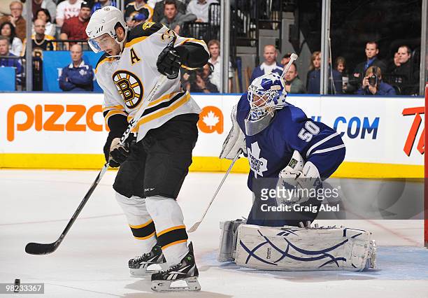 Patrice Bergeron of the Boston Bruins is stopped in close by Jonas Gustavsson of the Toronto Maple Leafs during game action April 3, 2010 at the Air...