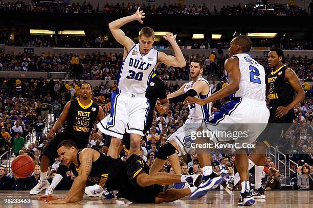 Joe Mazzulla of the West Virginia Mountaineers falls down as he goes after the ball next to Jon Scheyer of the Duke Blue Devils during the National...