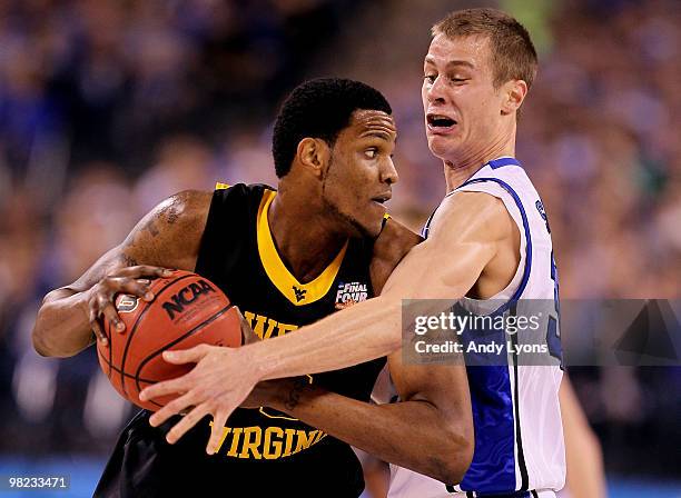 Devin Ebanks of the West Virginia Mountaineers looks to pass the ball against Jon Scheyer of the Duke Blue Devils during the National Semifinal game...