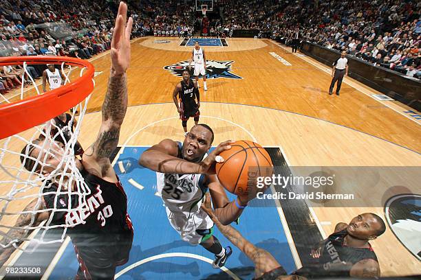 Al Jefferson of the Minnesota Timberwolves attacks the basket against Michael Beasley of the Miami Heat during the game on April 3, 2010 at the...