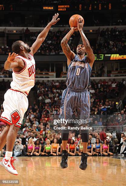 Larry Hughes of the Charlotte Bobcats shoots a jumper as Ronald Murray of the Chicago Bulls jumps in to block during the NBA game against the Chicago...