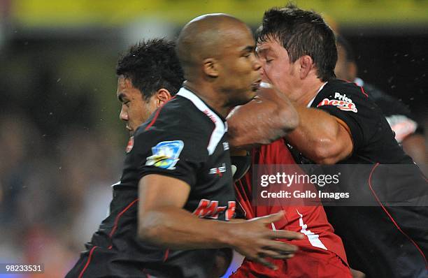 Digby Ione of the Reds tackled by JP Pietersen and Wilhelm Steenkamp of the Sharks during the Super 14 match between Sharks and Reds from Absa...