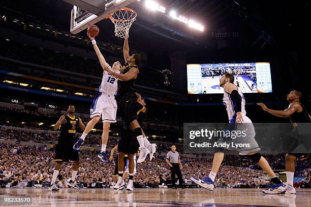 Kyle Singler of the Duke Blue Devils drives for a shot attempt in the first half against Wellington Smith of the West Virginia Mountaineers during...