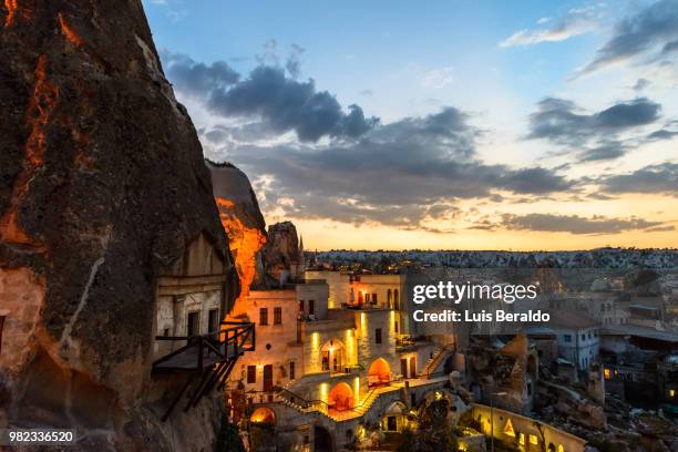 a village at sunset in goreme, turkey. - cappadocië stockfoto's en -beelden