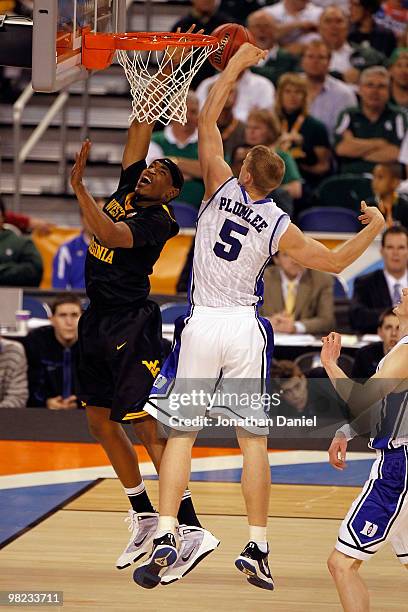 Kevin Jones of the West Virginia Mountaineers goes up for a shot against Mason Plumlee of the Duke Blue Devils in the first half during the National...