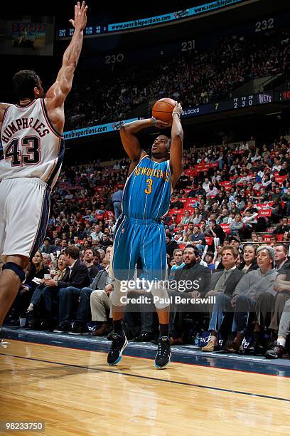 Chris Paul of the New Orleans Hornets shoots against Kris Humpries of the New Jersey Nets during a game on April 3, 2010 at Izod Center in East...