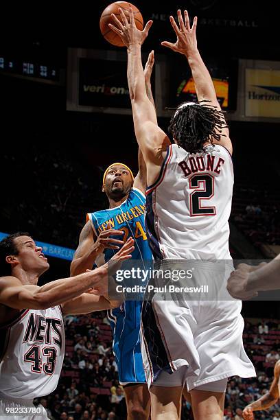Morris Peterson of the New Orleans Hornets shoots against Josh Boone of the New Jersey Nets during a game on April 3, 2010 at Izod Center in East...