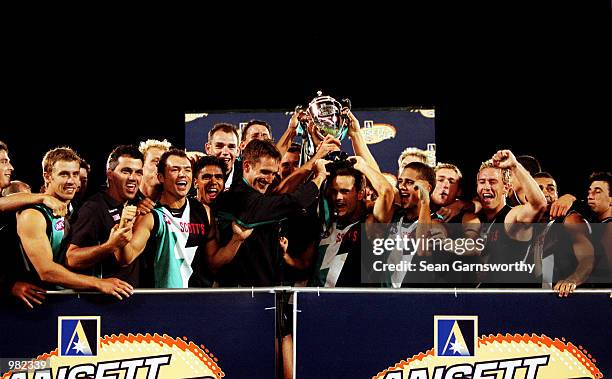 The Port Adelaide team celebratesa after winning the Ansett Cup Grand Final between Port Adelaide Power and Brisbane Lions at Football Park in...