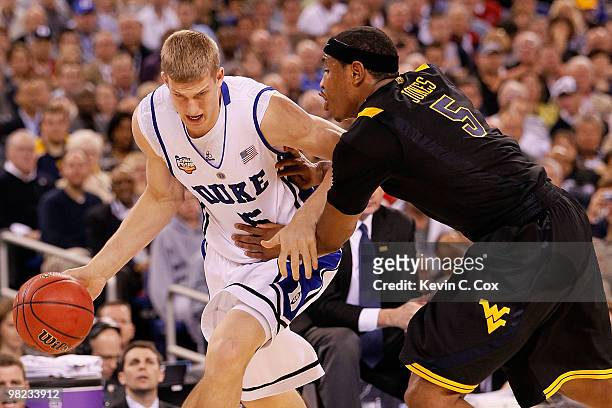 Mason Plumlee of the Duke Blue Devils drives on Kevin Jones of the West Virginia Mountaineers in the second half during the National Semifinal game...