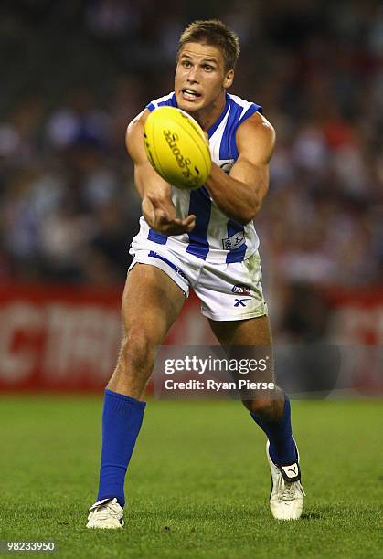 Andrew Swallow of the Kangaroos handballs during the round two AFL match between the St Kilda Saints and the North Melbourne Kangaroos at Etihad...