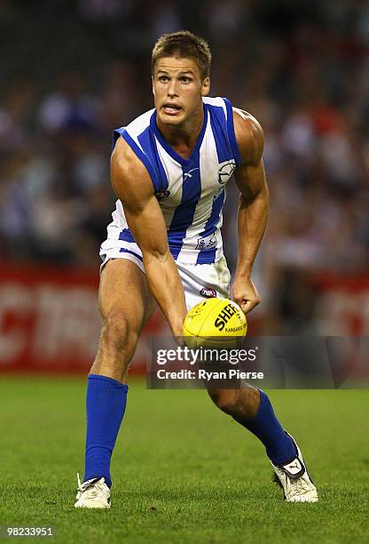 Andrew Swallow of the Kangaroos handballs during the round two AFL match between the St Kilda Saints and the North Melbourne Kangaroos at Etihad...
