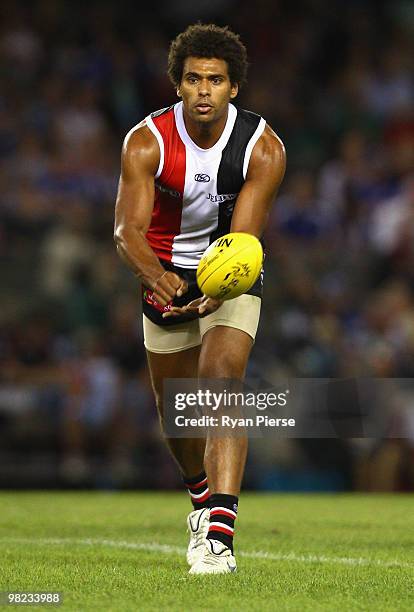 James Gwilt of the Saints handballs during the round two AFL match between the St Kilda Saints and the North Melbourne Kangaroos at Etihad Stadium on...