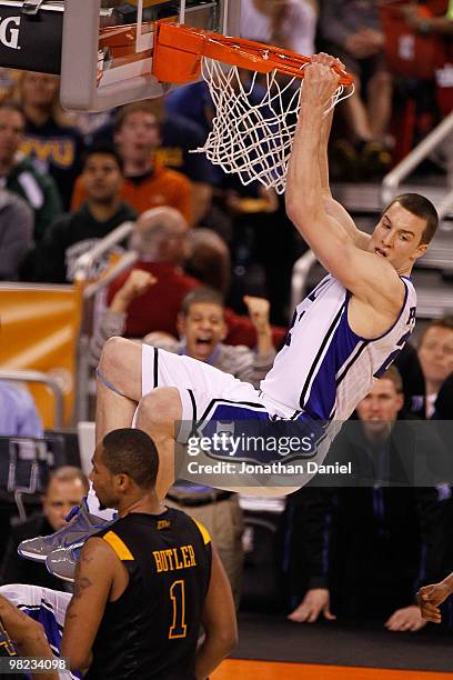 Miles Plumlee of the Duke Blue Devils dunks the ball as he is called for a technical foul for hanging on the rim in the second half against the West...