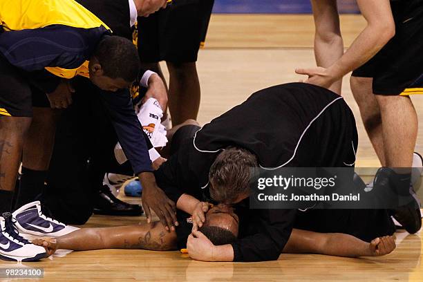 Head coach Bob Huggins consoles Da'Sean Butler of the West Virginia Mountaineers after Butler injured his knee in the second half against the Duke...