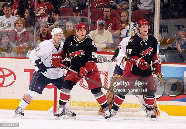 Shane Doan and Ed Jovanovski of the Phoenix Coyotes set up in front of the Taylor Chorney of the Edmonton Oilers and the Edmonton net on April 3,...