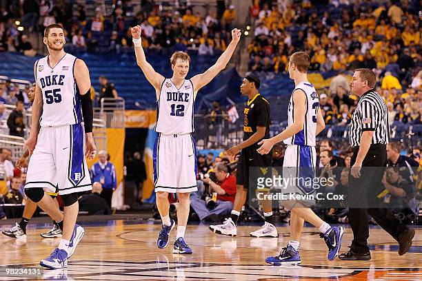 Brian Zoubek and Kyle Singler of the Duke Blue Devils react late in the second half against the West Virginia Mountaineers during the National...