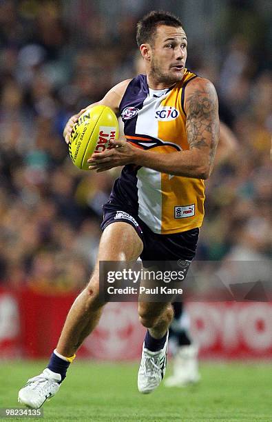 Chris Masten of the Eagles runs with the ball during the round two AFL match between the West Coast Eagles and Port Adelaide Power at Subiaco Oval on...