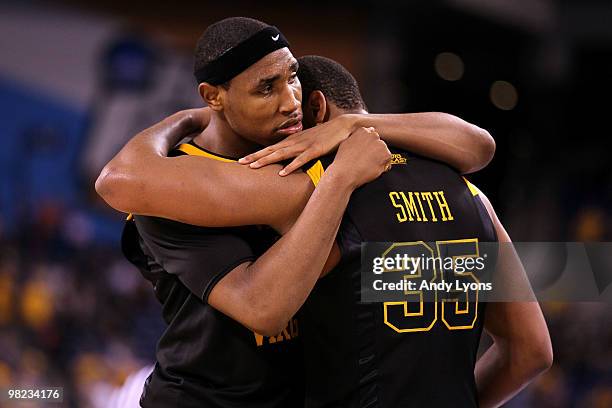 Kevin Jones and Wellington Smith of the West Virginia Mountaineers console each other after they lost 78-57 against the Duke Blue Devils during the...