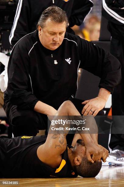 Head coach Bob Huggins consoles Da'Sean Butler of the West Virginia Mountaineers after Butler injured his knee in the second half against the Duke...