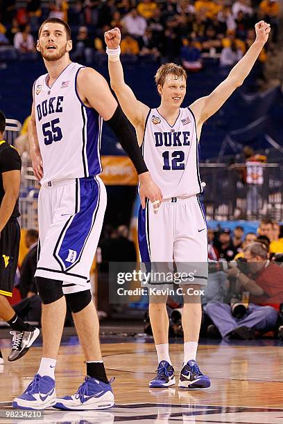 Brian Zoubek and Kyle Singler of the Duke Blue Devils react late in the second half against the West Virginia Mountaineers during the National...