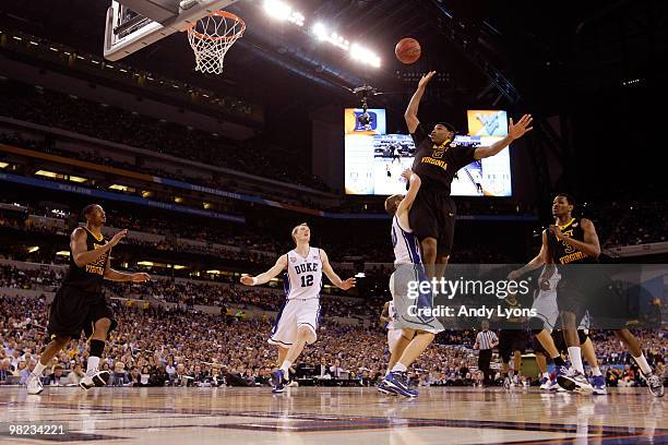 Kevin Jones of the West Virginia Mountaineers drives for a shot attempt against Jon Scheyer of the Duke Blue Devils during the National Semifinal...