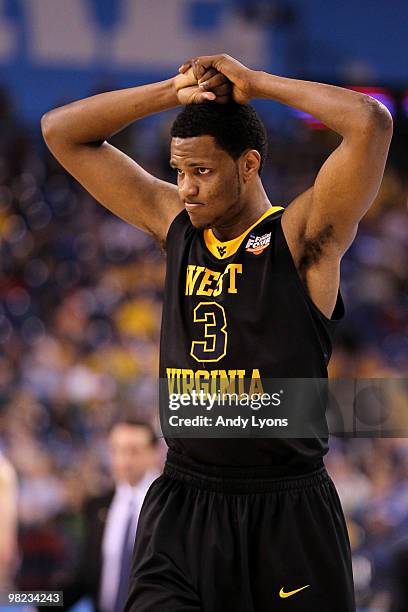 Devin Ebanks of the West Virginia Mountaineers walks on the court with his hands on his head against the Duke Blue Devils during the National...