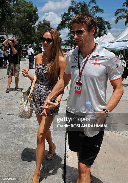 McLaren-Mercedes driver Jenson Button of Britain holds hands with his girlfriend Jessica Michibata as they arrived for the Formula One's Malaysian...