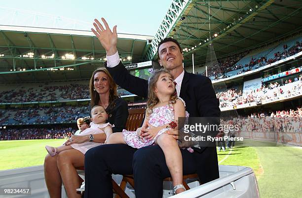 Former Essendon Champion Matthew Lloyd and his family wave to the fans as he is honoured before the round two AFL match between the Essendon Bombers...