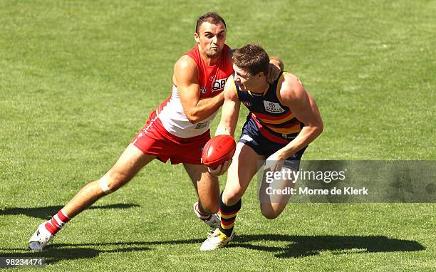 Patrick Dangerfield of the Crows is chased down by Rhyce Shaw of the Swans during the round two AFL match between the Adelaide Crows and the Sydney...